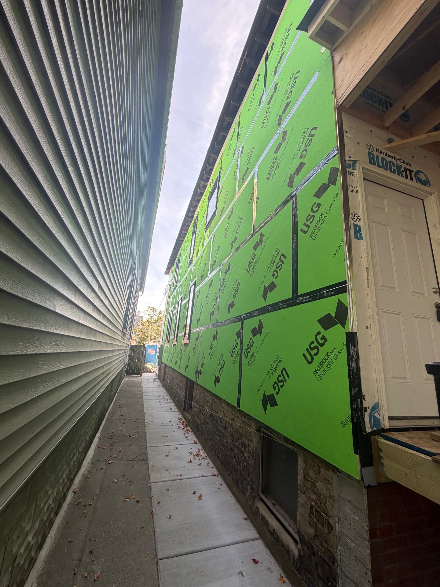 Chicago home wrapped and ready for new siding after lead-safe removal (After)