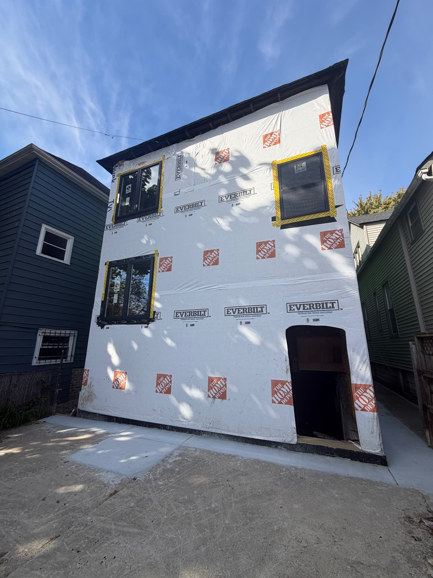 Chicago home wrapped and ready for new siding after lead-safe removal (Before)