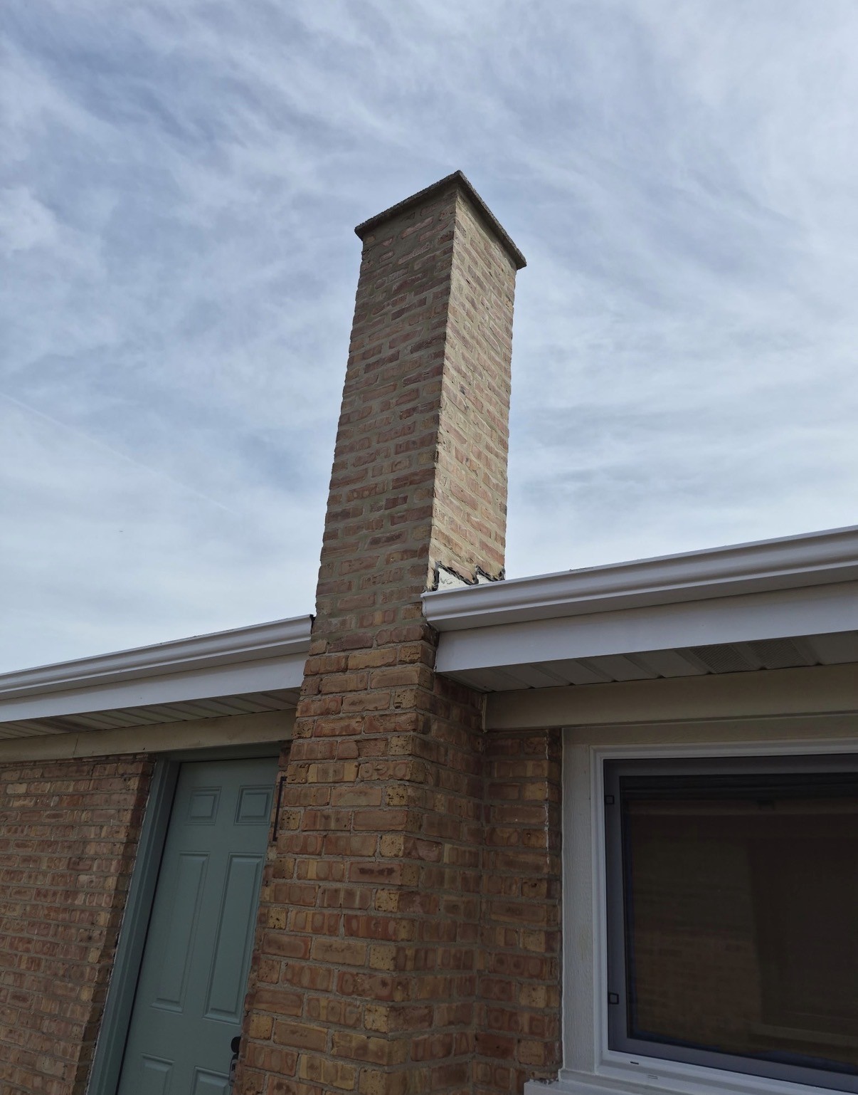 Chimney of a Jefferson Park home before and after tuck-pointing and brick repair (After)