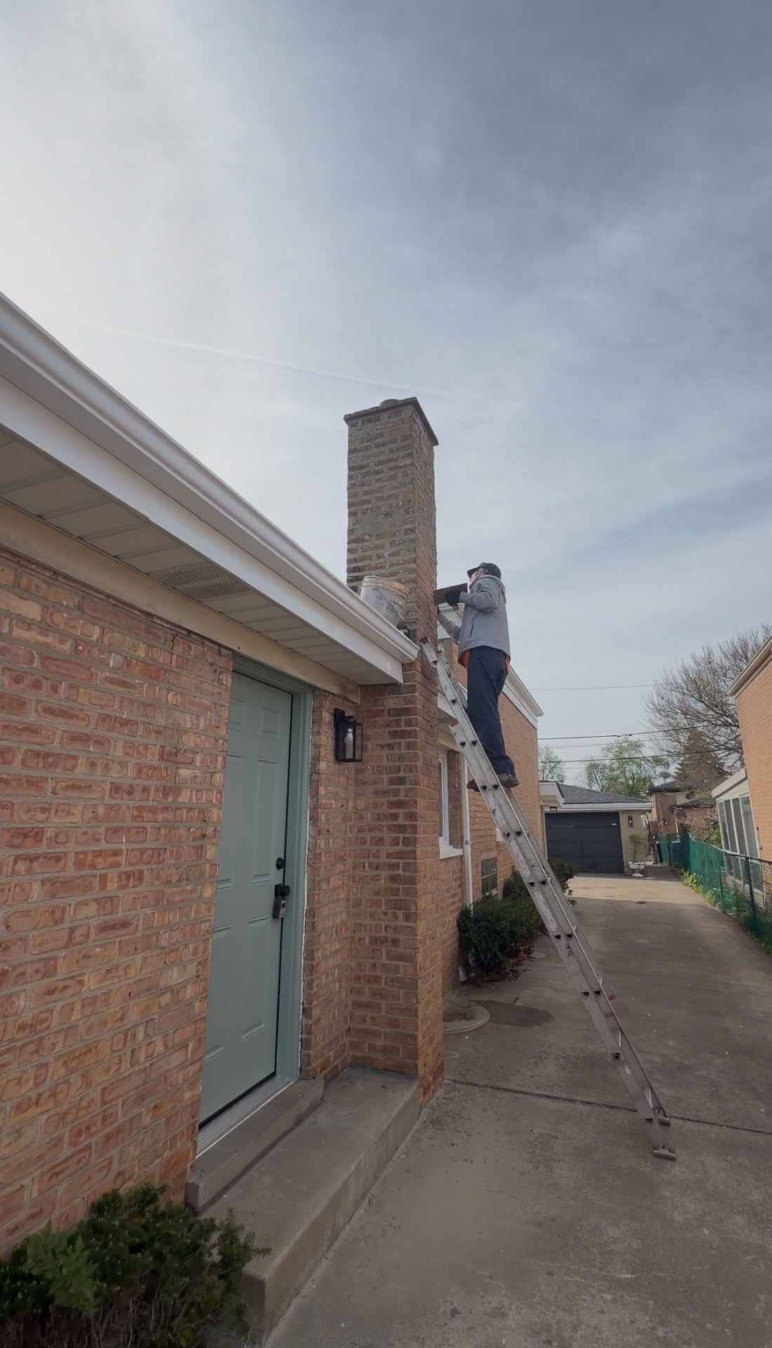 Chimney of a Jefferson Park home before and after tuck-pointing and brick repair (Before)