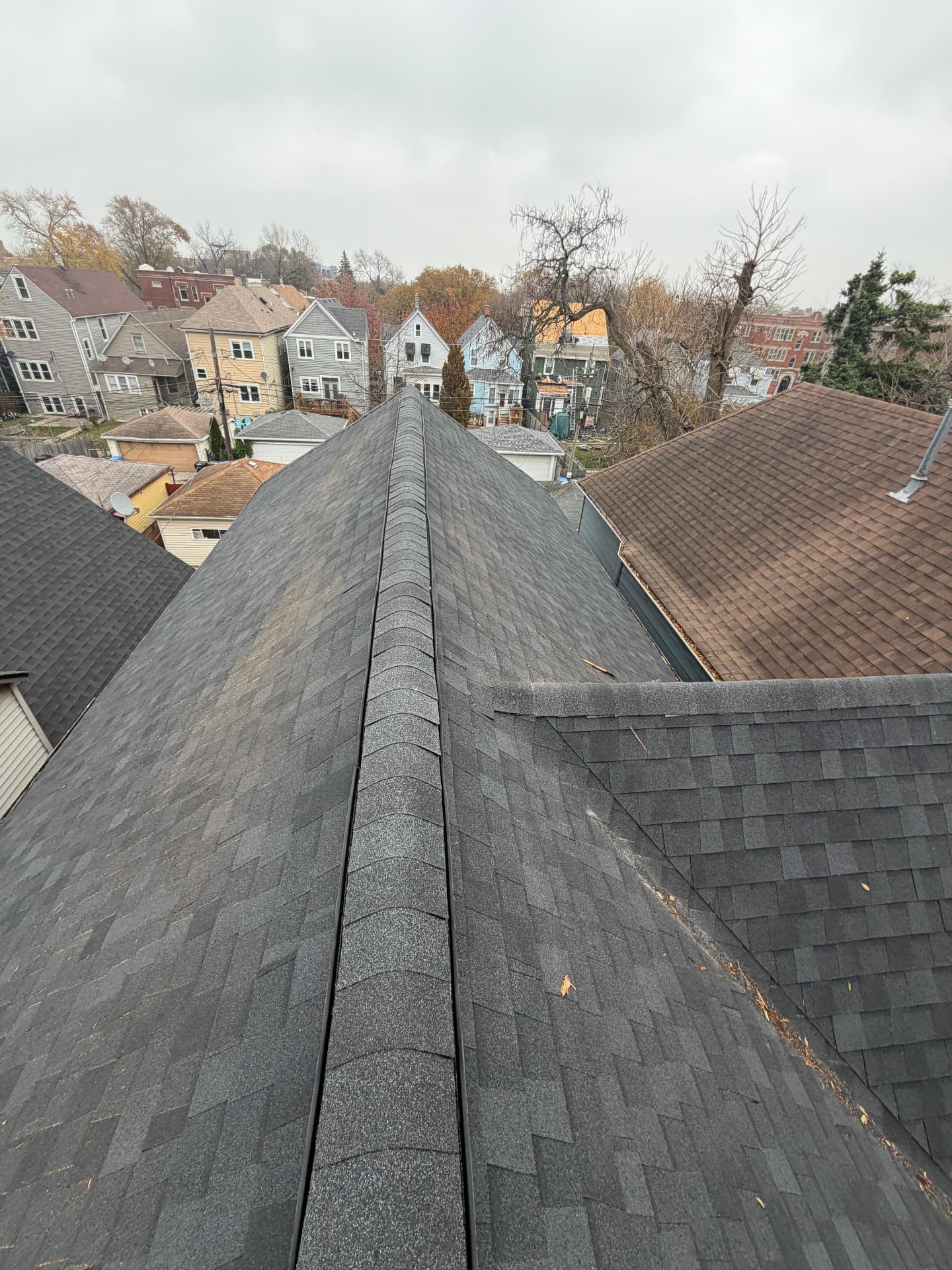 Two-story shingle roof in Logan Square before and after a full replacement (After)