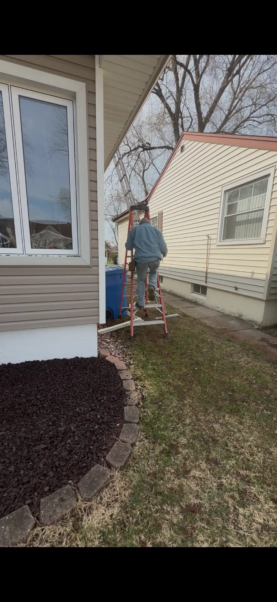 House gutter and downspout before and after a new gutter installation with extra downspouts (Before)