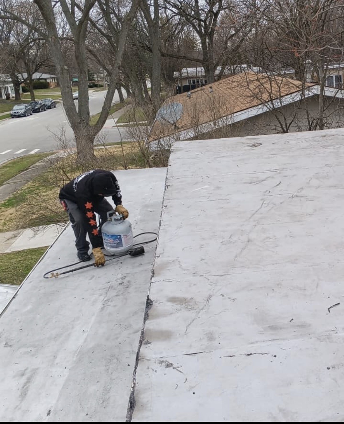 Torch-down flat roof in Chicago after high winds lifted the membrane (After)